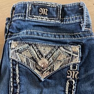 Dark wash, boot cut, miss me jeans.